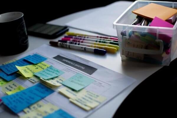 an image of a paper with lots of sticky notes on it.