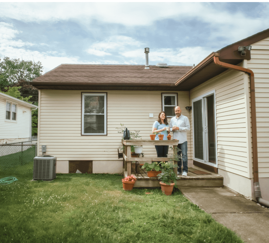 Mark & Barbara outside of their home