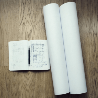 an image of an architects notebook and blueprints